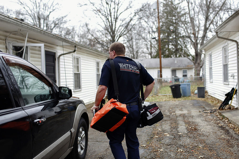 MTStory - 2nd place   - Randy Jones, a paramedic with the Whitehall Division of Fire, walks up the driveway to Maxine Welsh's home. The Whitehall Fire Department is one of a growing number of departments in central Ohio with a community paramedic. It's a proactive approach to reducing ambulance runs and improving resident safety. The paramedic tracks homes with frequent ambulance calls and meets with them regularly to try to address the underlying issues. (Joshua A. Bickel / The Columbus Dispatch)